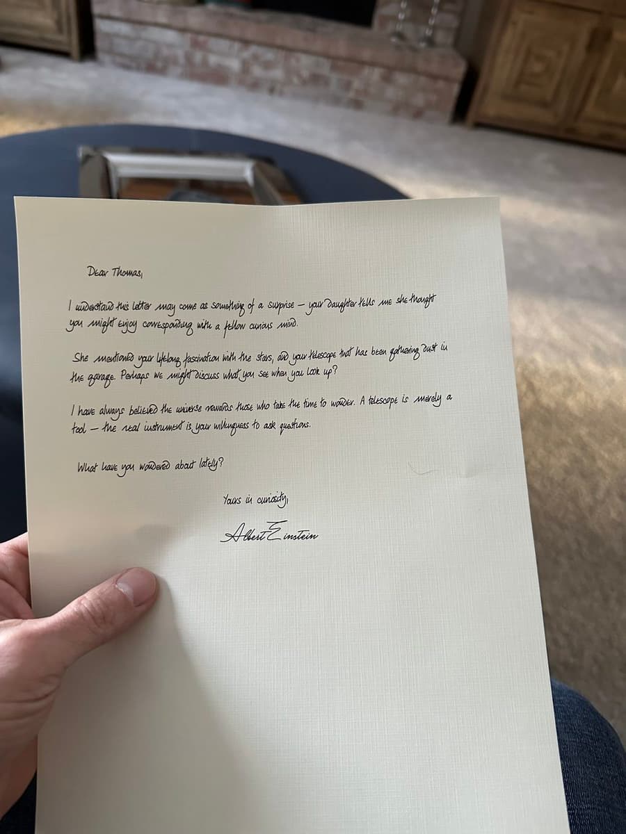 Someone holding and reading a handwritten letter in their living room